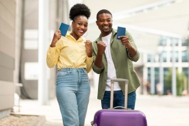 Black travelers couple gesturing yes holding passports near airport outdoors _ Premium Photo